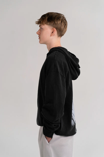 Side view of the Open Source Jesus Presence Hoodie in Washed Black on a model